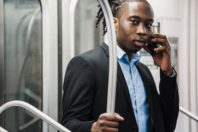 man talking on phone in train