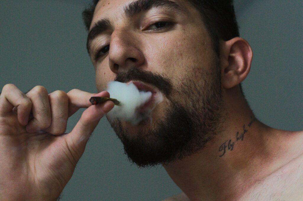 Man Smoking Tobacco Inside Room