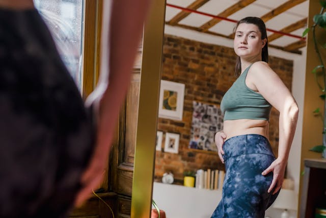 woman checking herself in the mirror