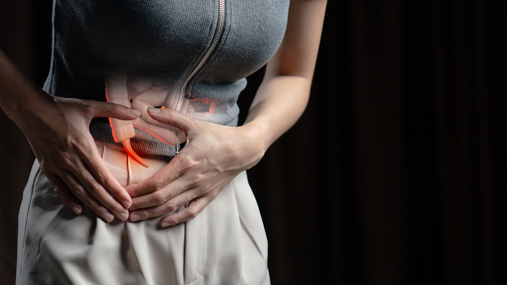 Abdominal pain woman, photo of large intestine on woman body, appendix pain. Health care concept.

