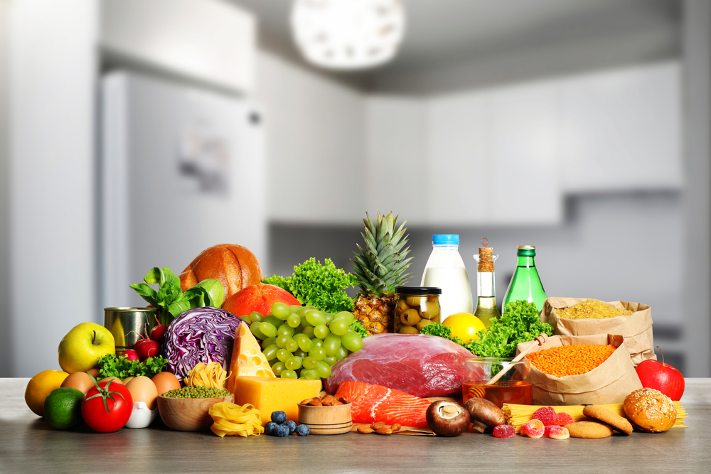 Different products on wooden table in kitchen. Healthy food and balanced diet