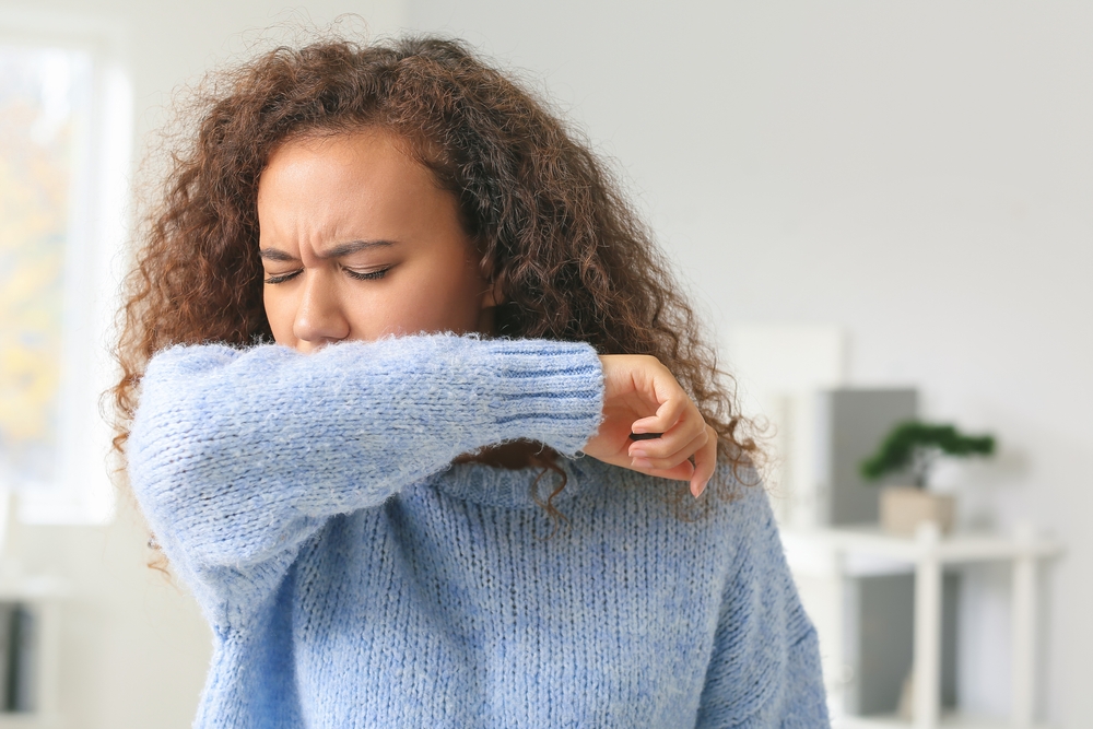 Coughing African-American woman at home