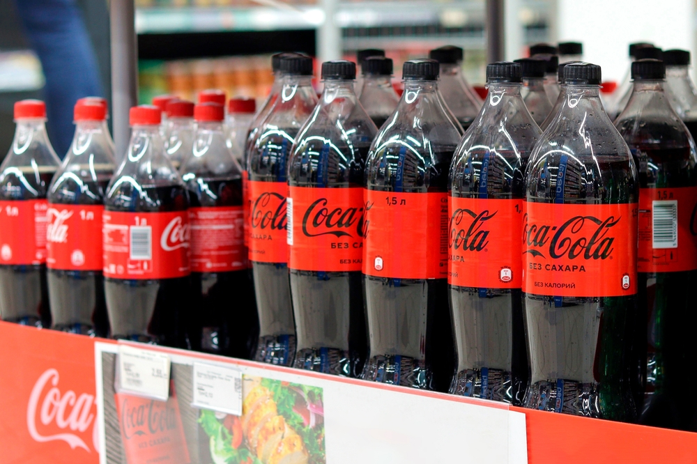 Soligorsk, Belarus, October 1, 2022: Coca-Cola plastic bottles are on display at the stand. Coca-Cola Company is the leading producer of carbonated beverages in the world.