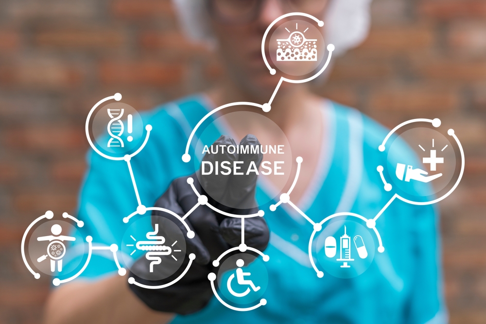 Young doctor using virtual touch screen presses inscription: AUTOIMMUNE DISEASE. Autoimmune Disease Medical concept.