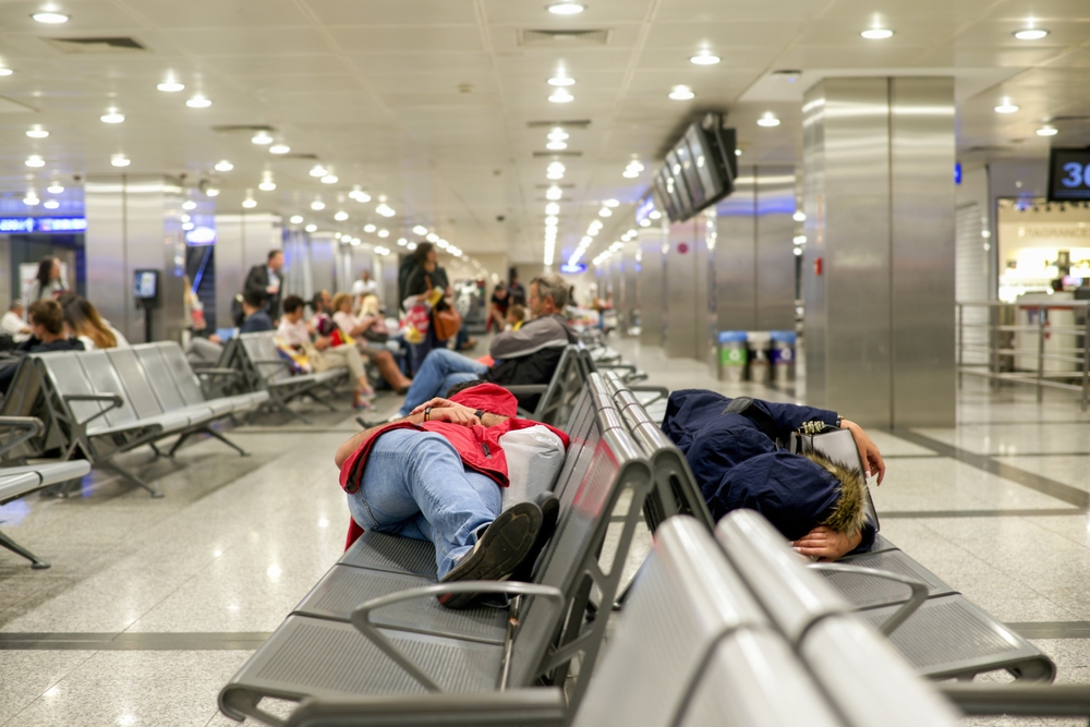 some people lay down sleep at the airport waiting for connecting fight