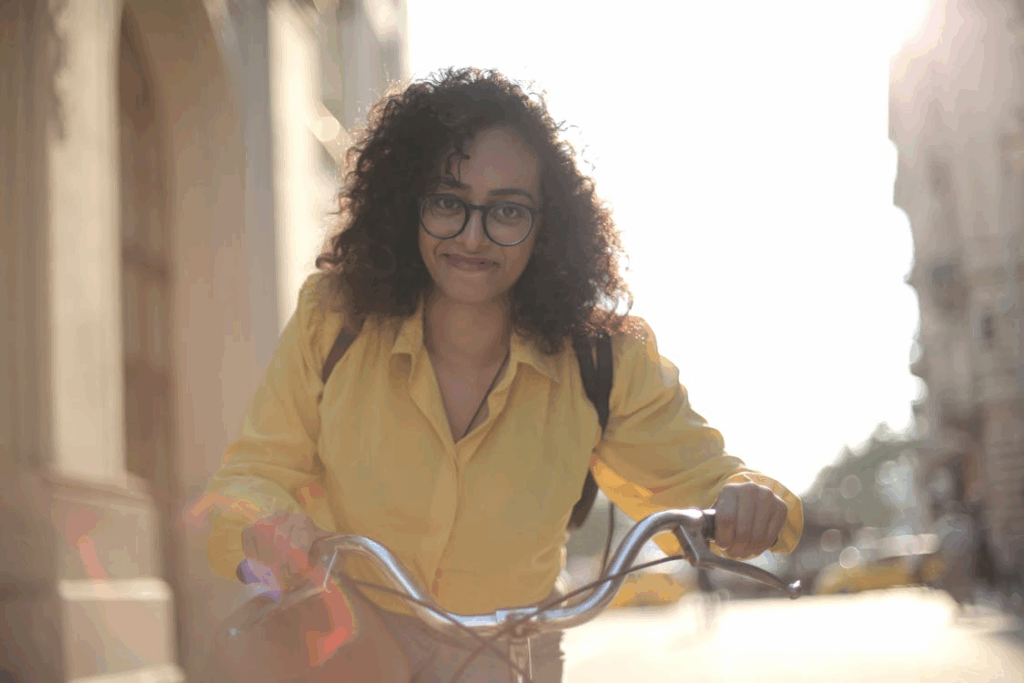 Happy female traveler with bike on street in downtown