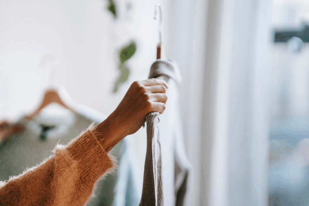 woman's arm holding up shirt