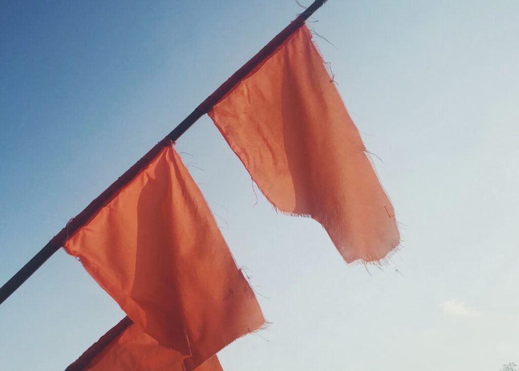 Two red flags flying together indicating water is completely closed to the public due to extreme danger.