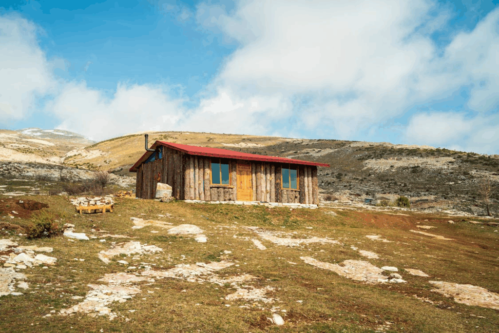 Clouds over Hill with Wooden House