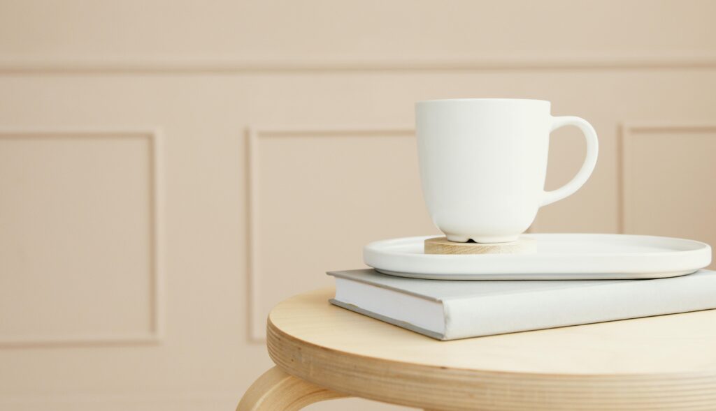 White cup on books