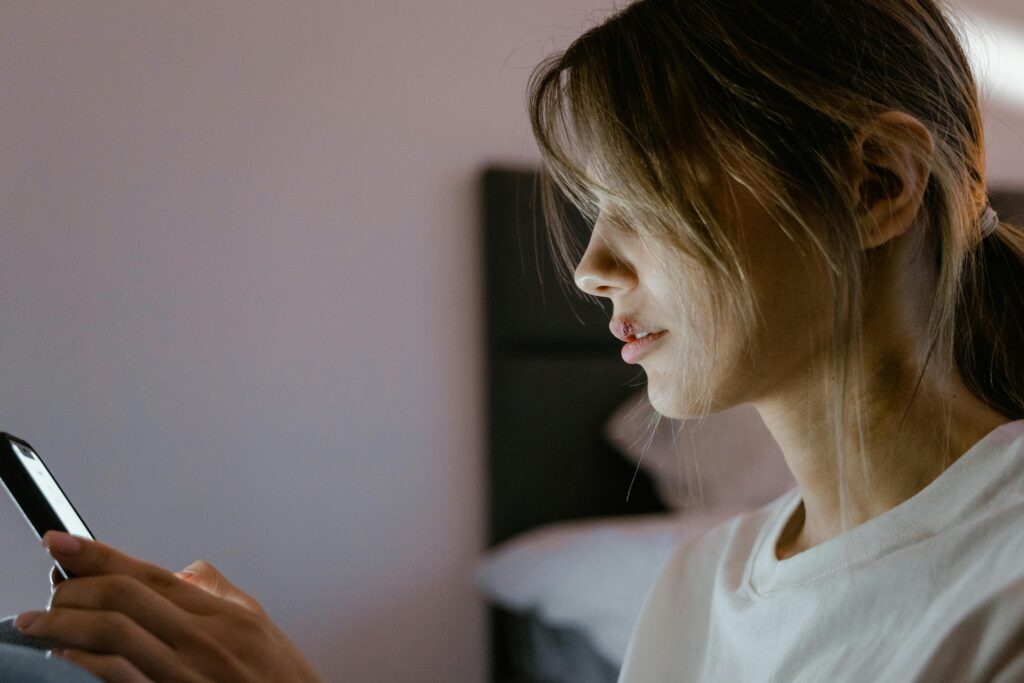 Close-Up Shot of a Woman Using a Mobile Phone
