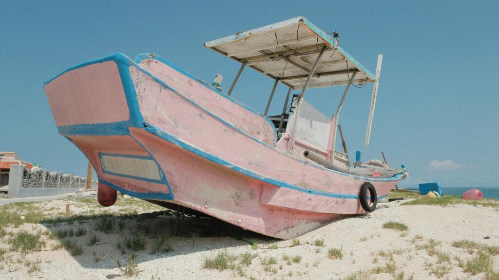 A Broken Wooden Boat on the Shore
