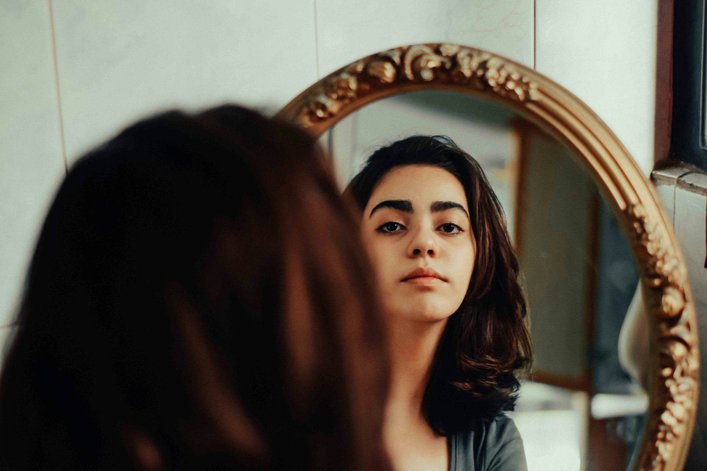 woman looking in the mirror