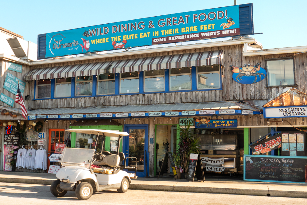 CEDAR KEY, FLORIDA - NOVEMBER 26, 2019: Shops and restaurants are open for business along the Gulf of Mexico waterfront in Cedar Key, Florida