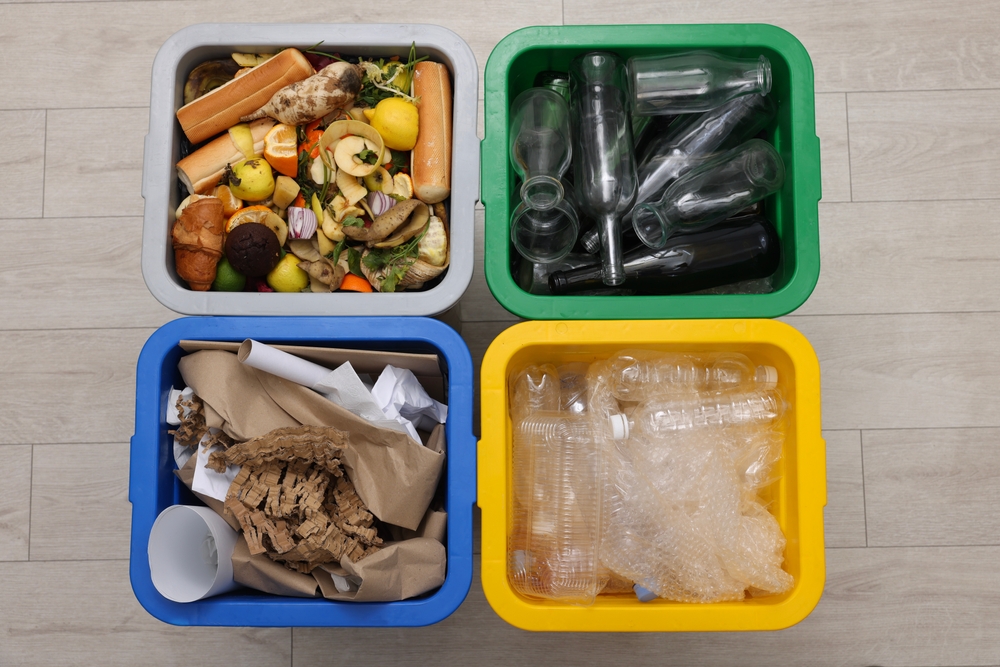 Garbage sorting. Full trash bins for separate waste collection indoors, top view