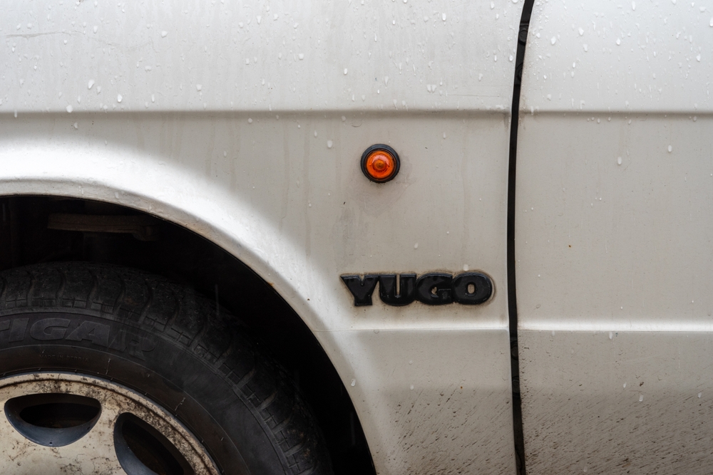 Belgrade, Serbia. May 3rd 2024. Side detail showing round indicator and logo on a classic Yugo car, made in Yugoslavia.
