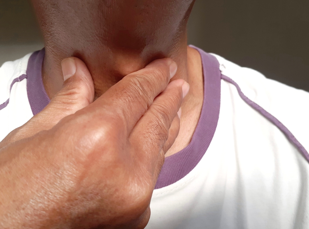 A man touches the neck with his finger. Checking the neck. Illustration of a sore throat.