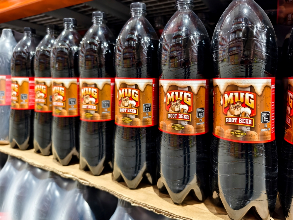 Philippines - May 11, 2025: Mug Root Beer no caffeine soft drink bottles arranged in rows, ready for purchase.