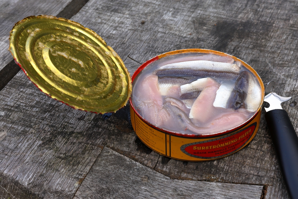 Stockholm, Sweden. 08-23-2025. Sour herring with opened tin. Very smelly fermented fish called surströmming in Swedish. Eat outside.
From Röda Ulven.