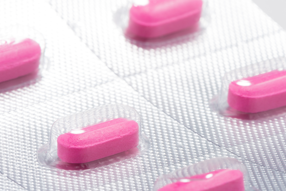 Pink antihistamine benadryl allergy tablets in clear blister pack