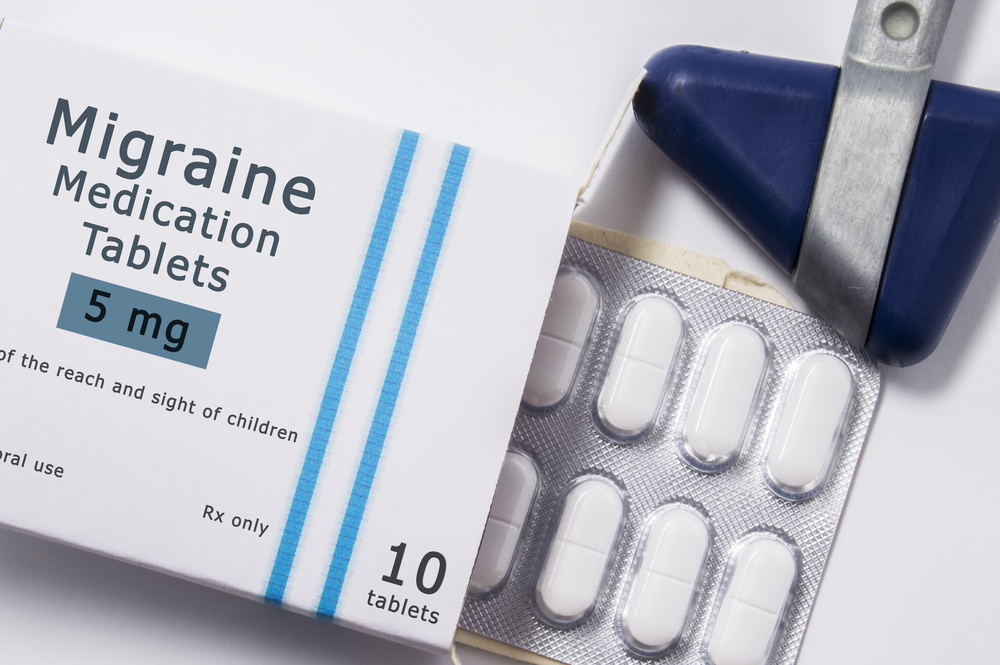 Anti Migraine drug. Neurological reflex hammer and packaging box of medication with name group of drug Migraine with blister with pills on white background close up. Concept for treatment of migraine