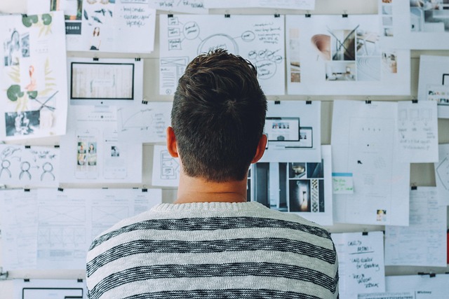 a man looking at a wall of information