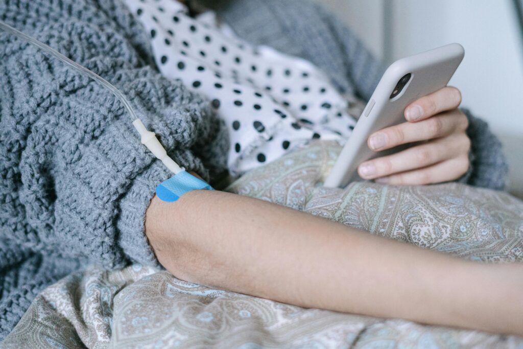 A Patient Using a Phone while Under Treatment
