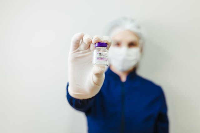 doctor holding a bottle of botox