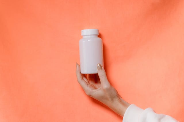 a hand holding a bottle