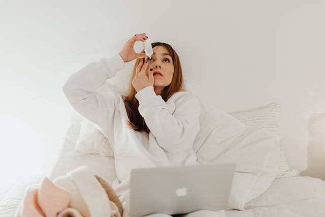 a woman putting Vizz in her eyes