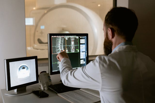 doctor pointing at bones on an x-ray