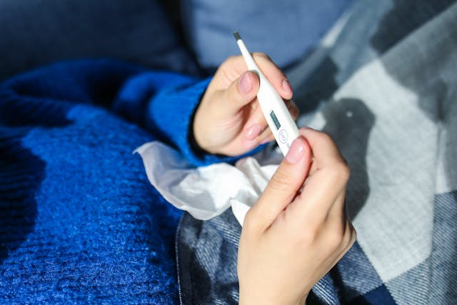 person checking temperature for fever