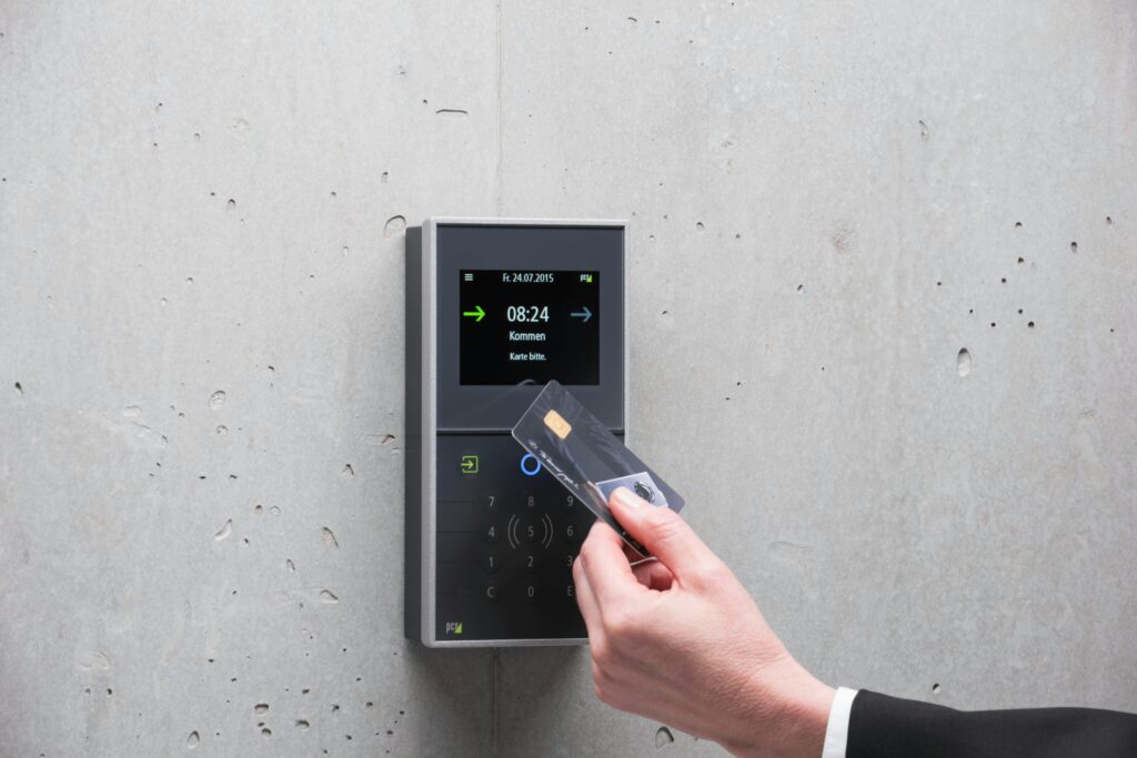Man Hand Holding Access Card over Reader
