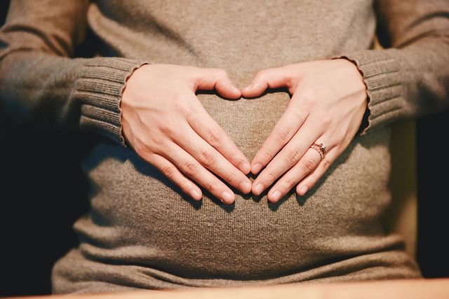 a woman holding her pregnant belly