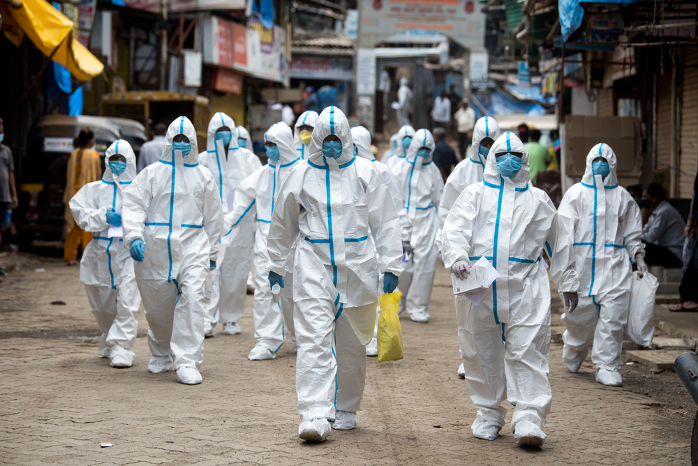 MUMBAI/INDIA- JUNE 25, 2020: Health workers wearing personal protective equipment arrive to take part in a check up camp at a slum in Malad during the COVID-19 Coronavirus pandemic.