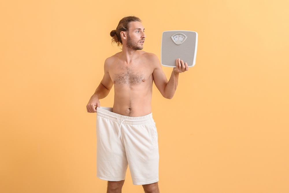 Man with sudden weight loss problem on color background. Diabetes symptoms