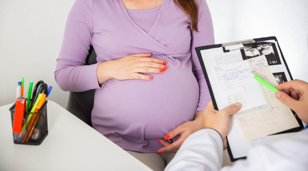 Pregnant girl at the doctor's consultation. The results of blood tests of a pregnant girl. Decrease in hemoglobin and blood sugar during pregnancy, immune system
