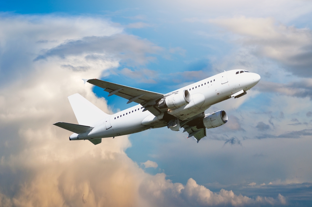 Airplane flying in the sky - travel background
