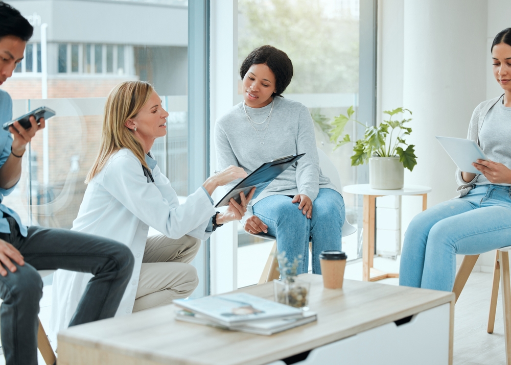 Women, doctor and explain for patient with form for clinical study, research and participation rules. People, medical professional and serious with file or folder with details and agreement at clinic