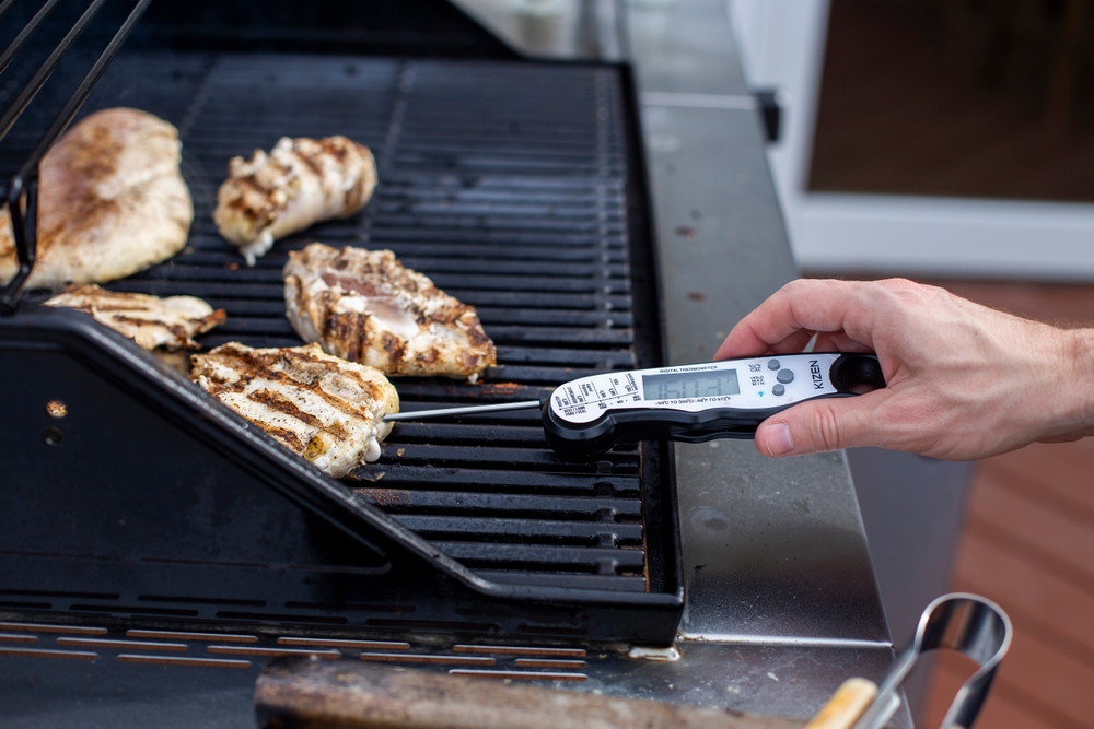Missouri Valley, Iowa United States June 14, 2025 A digital thermometer checking the temperature of grilled chicken