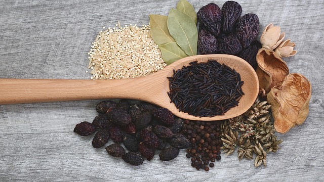 various spices around a wooden spoon