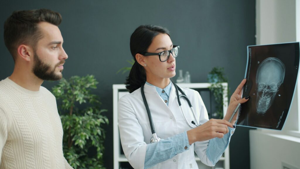 Doctor explains skull x-ray to patient