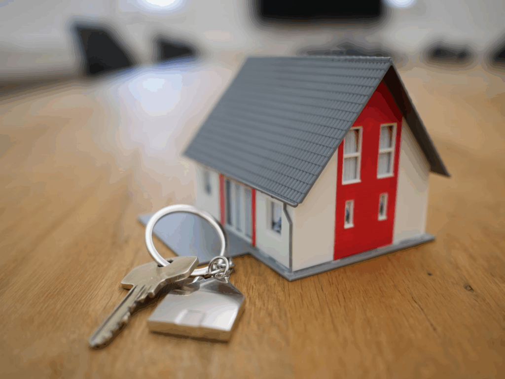 toy house on table next to set of keys