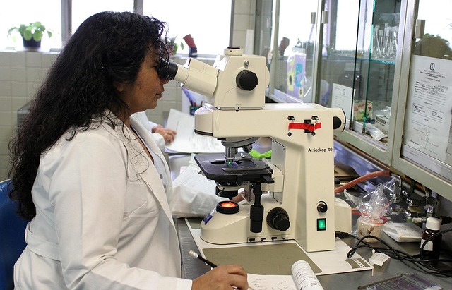 doctor ooking into microscope