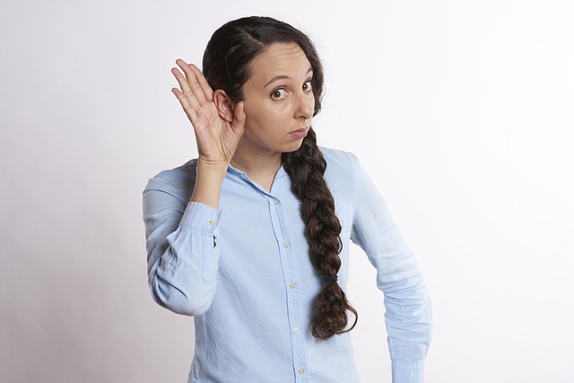 woman holding ear