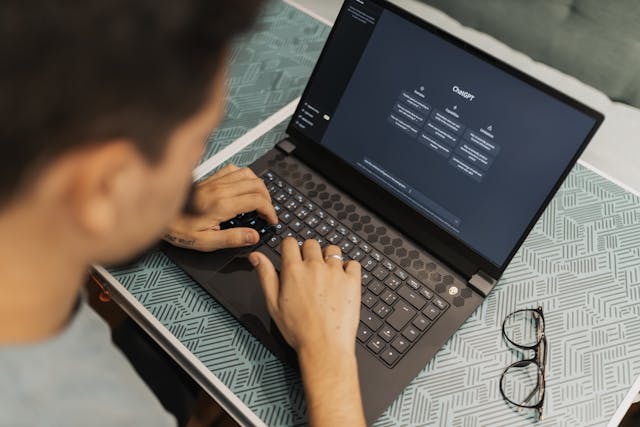 man using AI on laptop