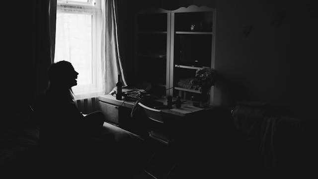 woman sitting in a dark room