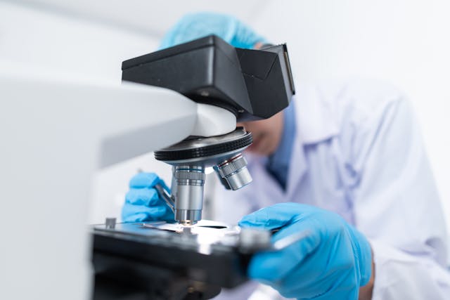 researcher looking at sample
