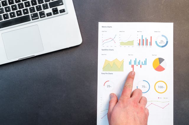 hand pointing to data sheet