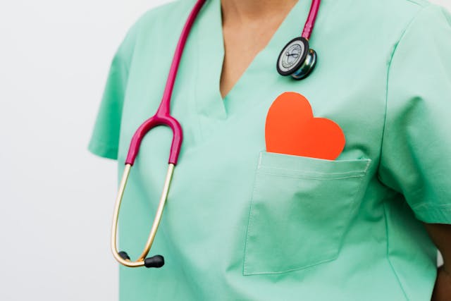Nurse with paper heart in her pocket